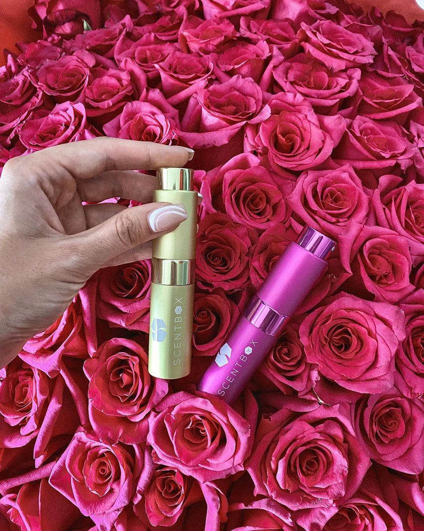 Woman holding ScentBox atomizer in a lifestyle setting